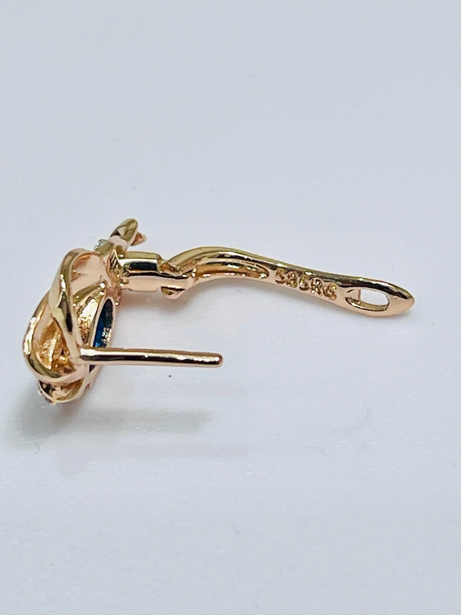 Gold earring on a white background