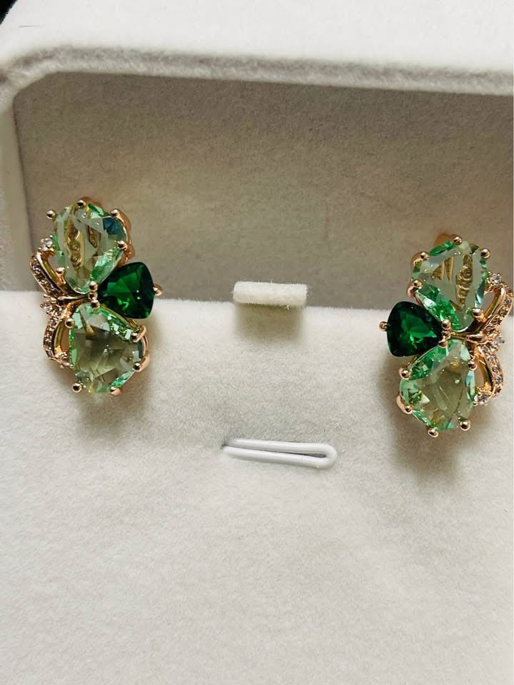 Two-tone green butterfly stud earrings crafted in 14k rolled gold with sparkling white accents