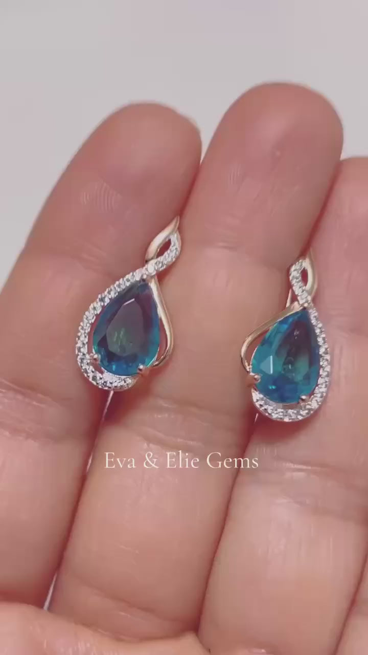 These exquisite earrings showcase beautiful teardrop-shaped blue topaz stones in a classic and elegant design.