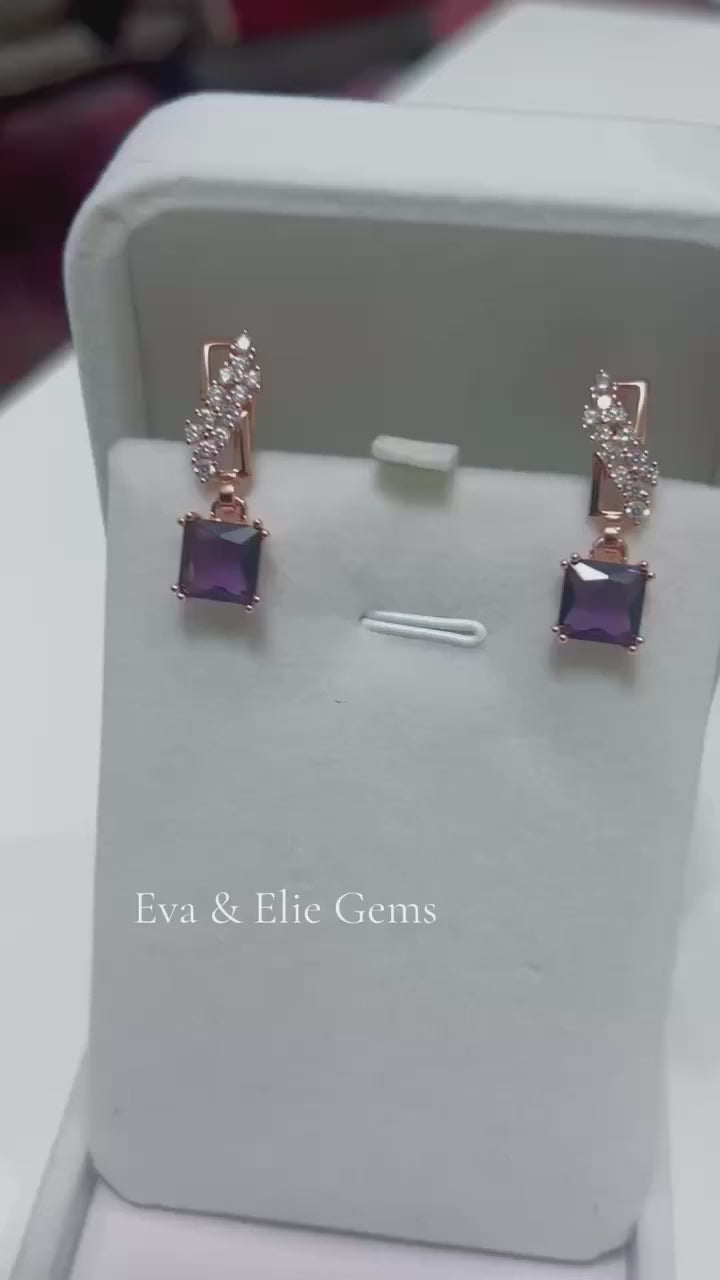 These elegant 14k rolled gold drop earrings showcase beautiful square amethyst stones.