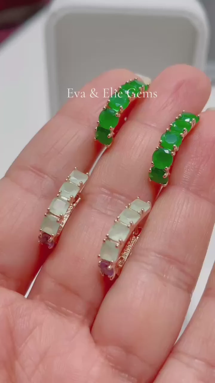 These huggie hoops feature light green square stones in a stylish 14k rolled gold setting.