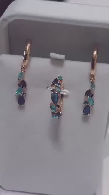 This jewelry set features a beautiful teardrop design with blue and green gemstones.