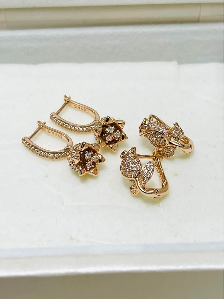 Rose gold-plated huggie earrings with flower pendants, stamped 585RG, detailed with CZ stones.