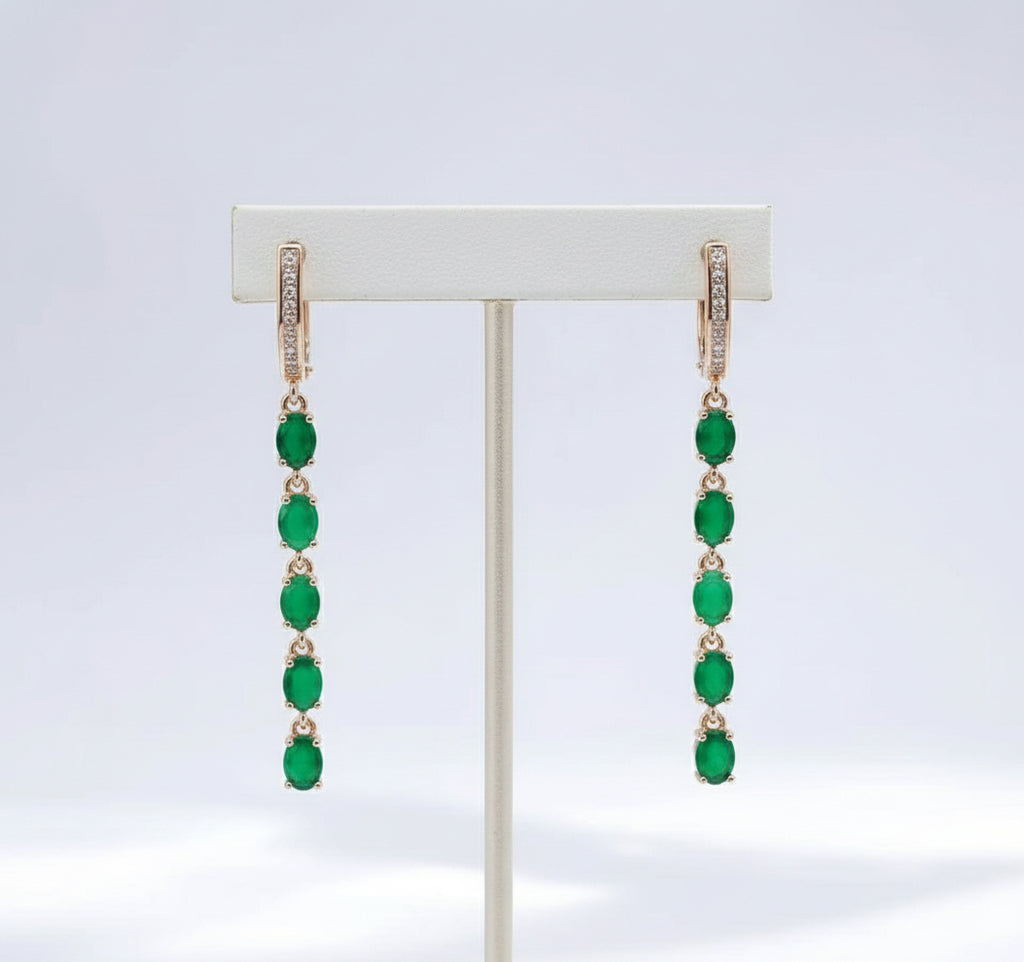 A pair of 14K rose gold filled long fancy earrings with a chain of natural green emeralds and cubic zirconia.