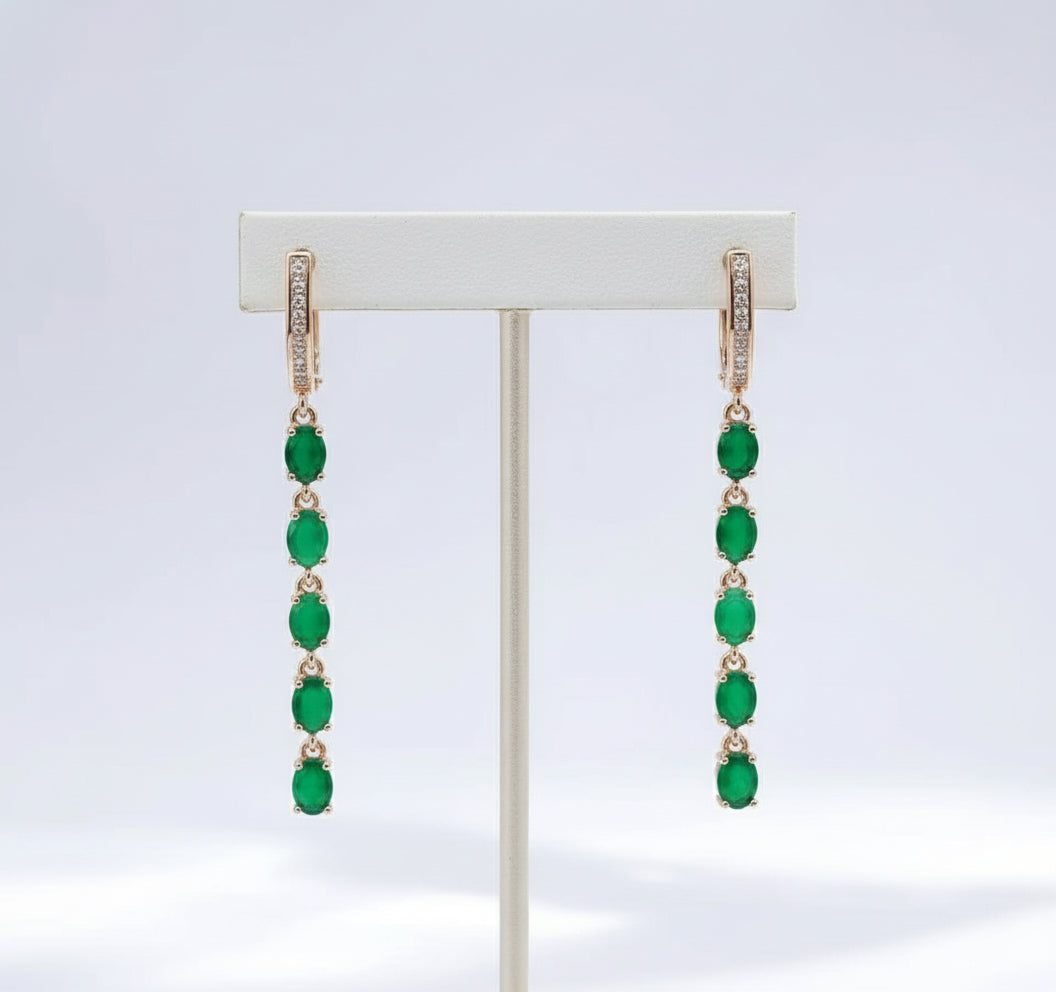 A pair of 14K rose gold filled long fancy earrings with a chain of natural green emeralds and cubic zirconia.