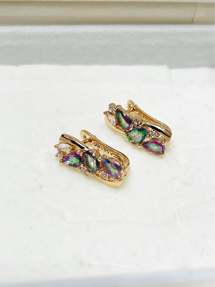 Angled view of 14k rose gold filled earrings with mesmerizing mystic topaz stones and brilliant accent crystals.
