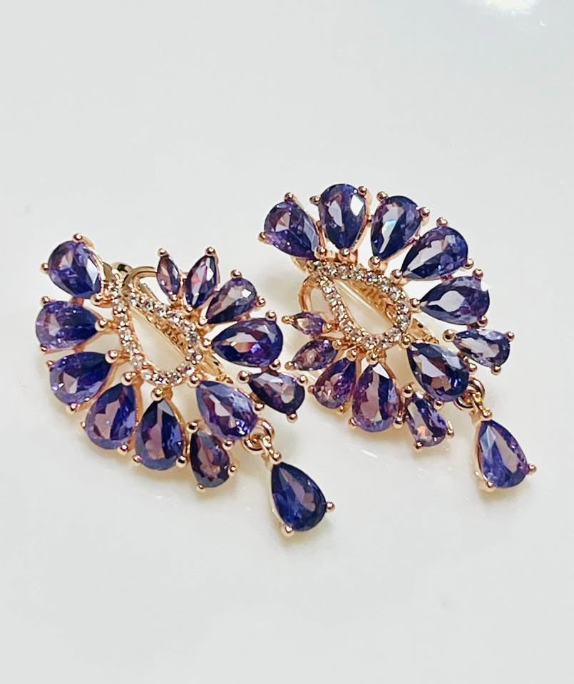 Close-up of 14K gold-filled earrings showcasing teardrop amethysts and cubic zirconia.