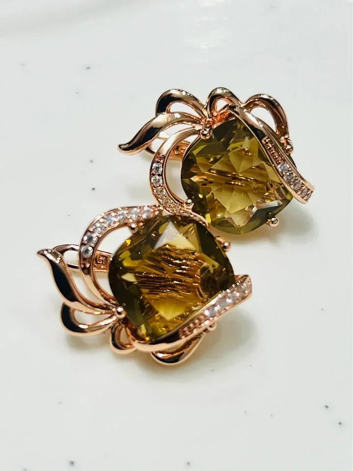  Stylish 14k gold-filled earrings with intricate designs and beautiful, faceted citrine gemstones on a white surface.