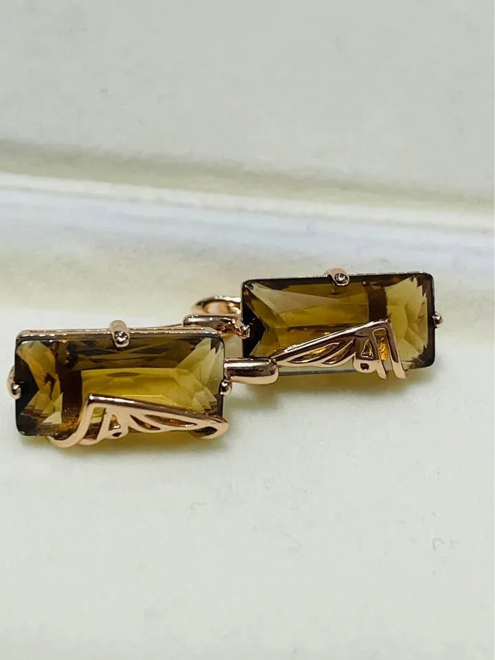 Angled view of 14K rolled gold citrine earrings, highlighting the detailed metalwork and stones.