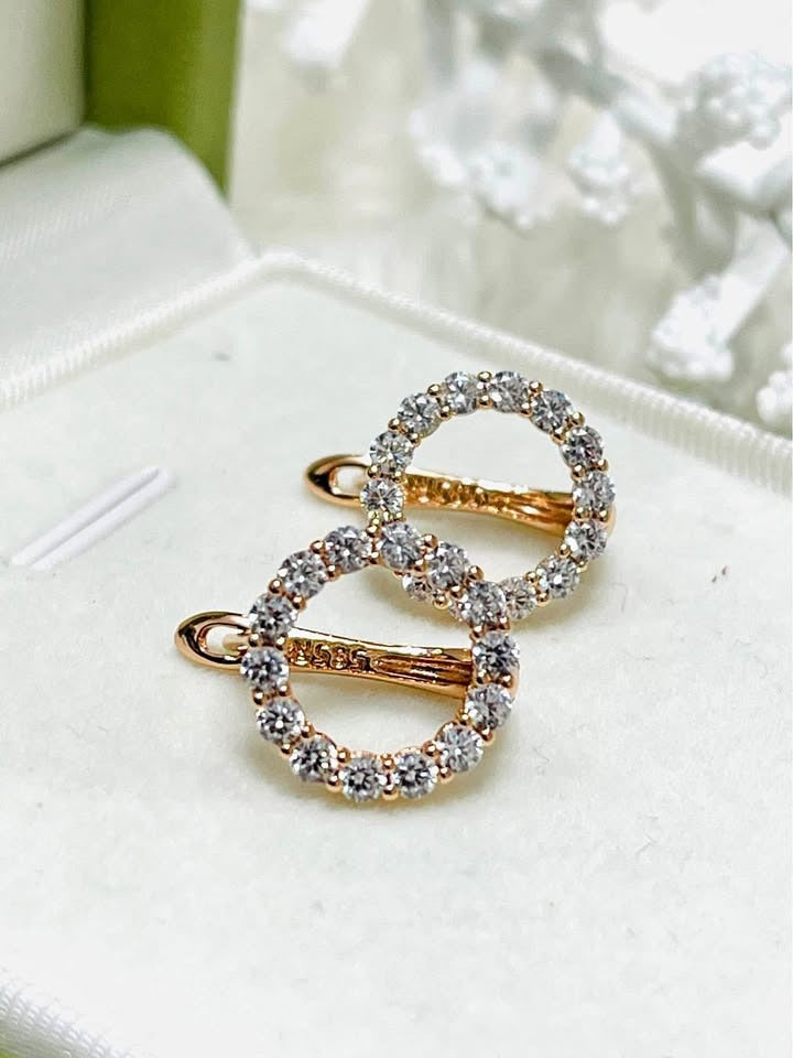 Close-up of 14K 585RG stamped rolled gold white round earrings in a jewelry box, showing detail.