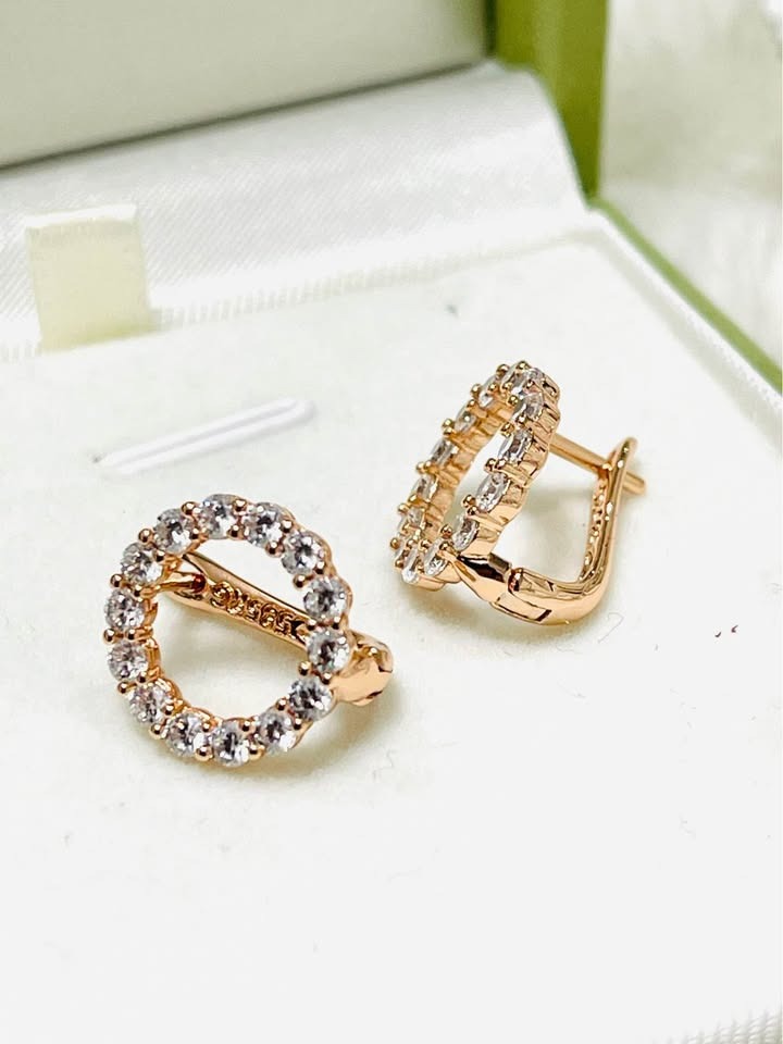 Pair of 14K 585RG rolled gold white round earrings with open clasps in a white box.