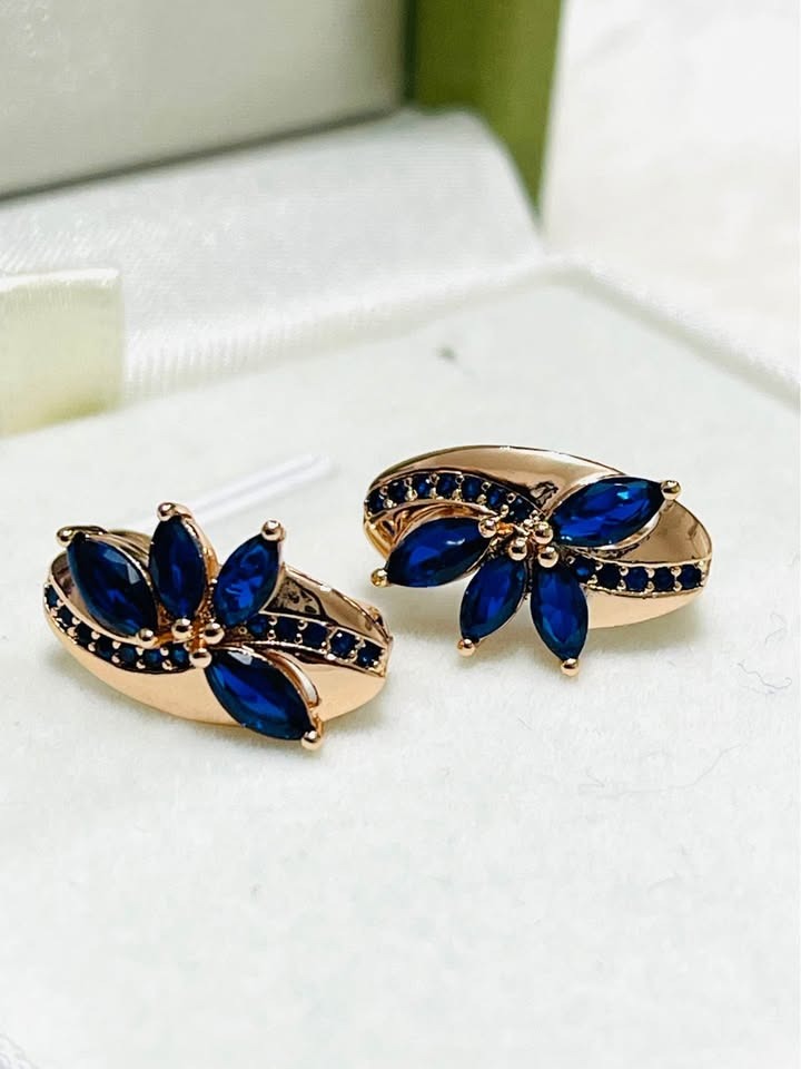 Pair of 14k 585RG rose gold earrings, designed as flowers with sparkling blue sapphire petals.