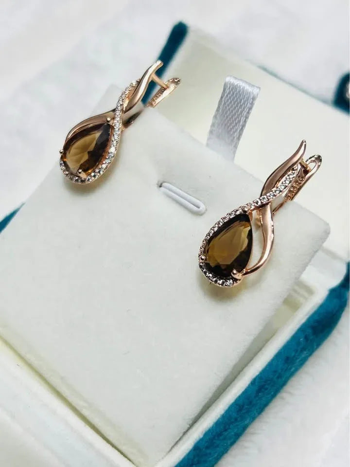 Angled view of 14K gold-filled citrine earrings with pave detailing, showcased in an open box.
