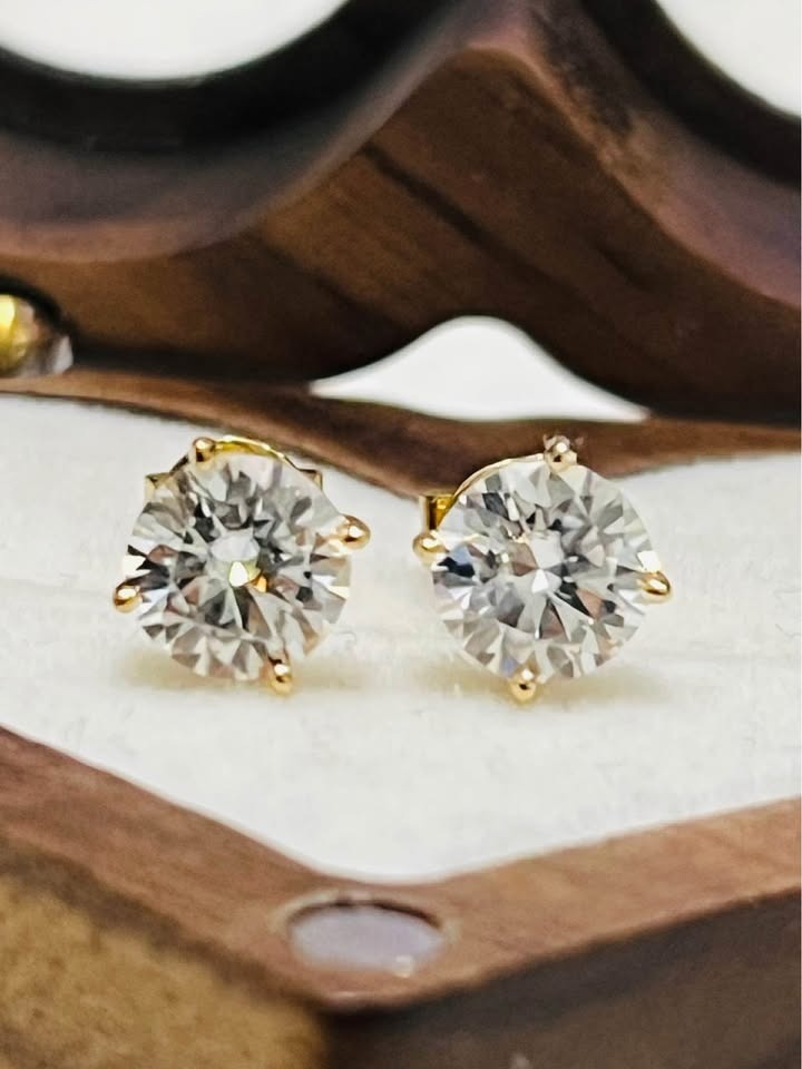Detailed shot of 14k gold Moissanite stud earrings, highlighting the clarity and sparkle of the stones.