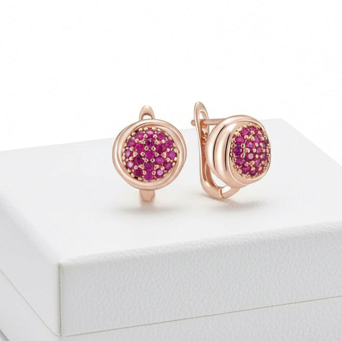 Pair of dainty 14k rose gold earrings with pave set pink zircons on a clean white background.