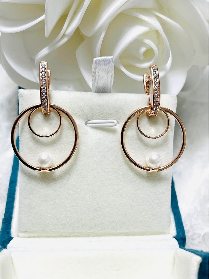 Front view of elegant 14k gold filled double hoop earrings with delicate pearls and paved accents.