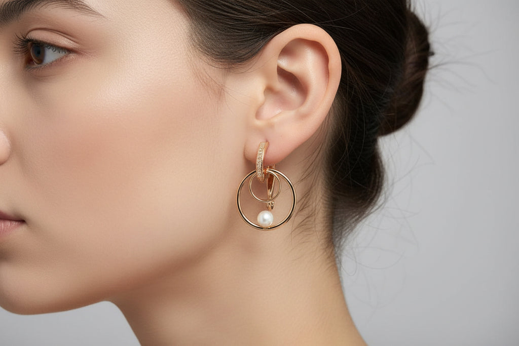 Elegant 14k gold filled double hoop and pearl earring worn on a black mannequin, showcasing style.