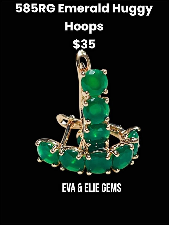 Striking 14k rolled gold huggy hoops with a row of natural emerald gemstones, shown against a black background.