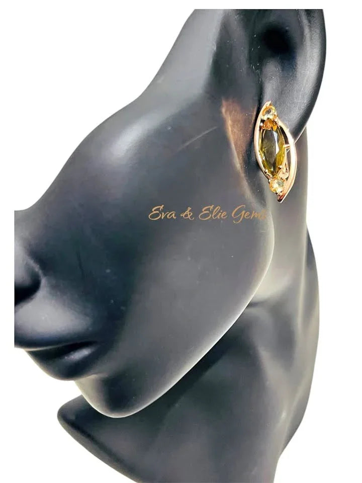 A single 14k rolled gold and citrine earring displayed on a mannequin to show its size and fit.