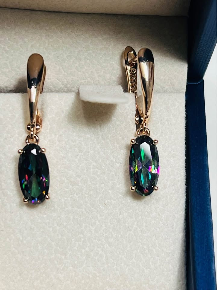 Close-up of 14k rose gold (585 stamped) dangle earrings featuring vibrant mystic topaz.
