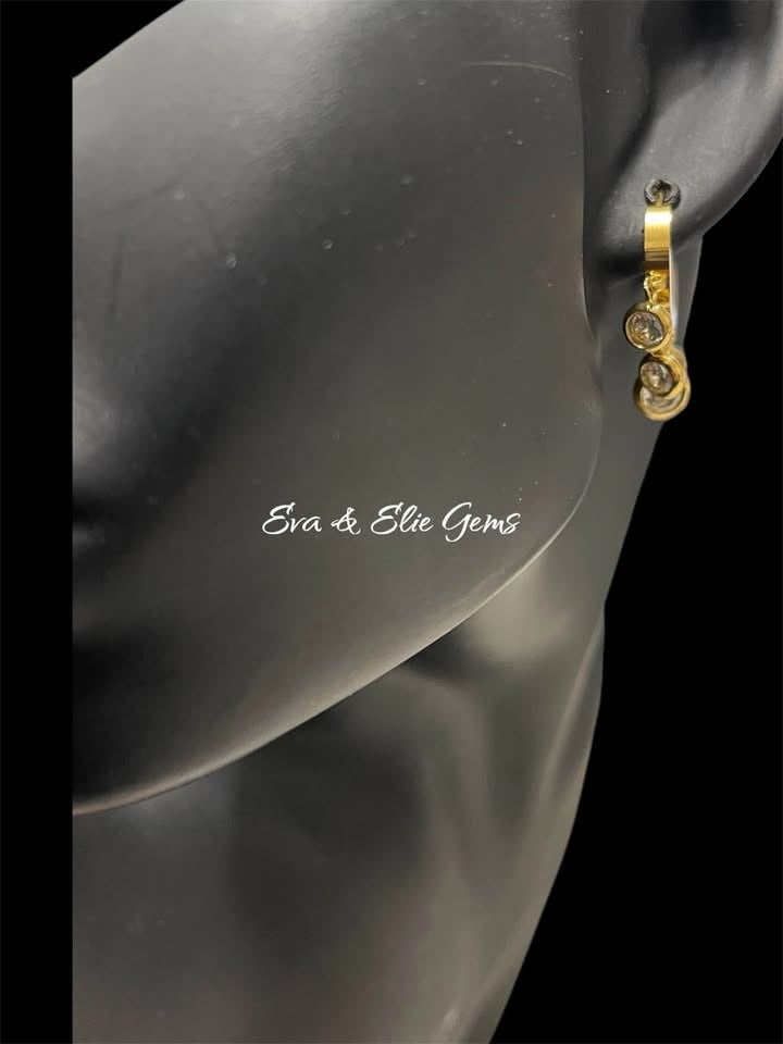 Side view of a single 18k gold vermeil fan hippie dangle earring on a black mannequin, from Eva & Elie Gems.