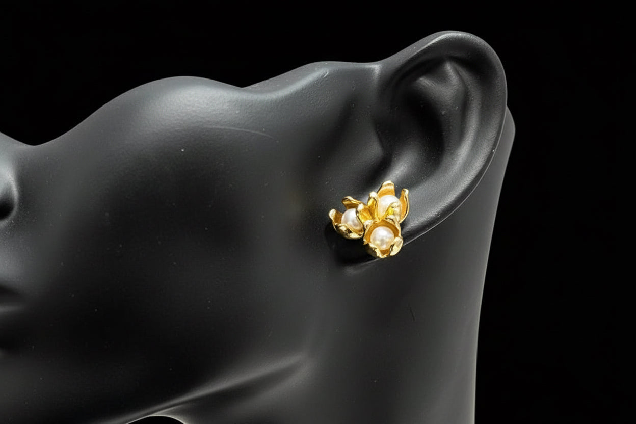  18k gold filled tulip earring with pearls, modeled on a black mannequin ear, elegant and classic.
