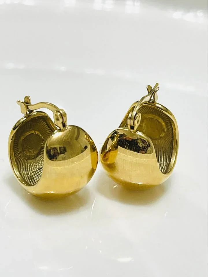  Angled view of 18k gold filled huggy hoops showing the waterproof design and ribbed inner texture.