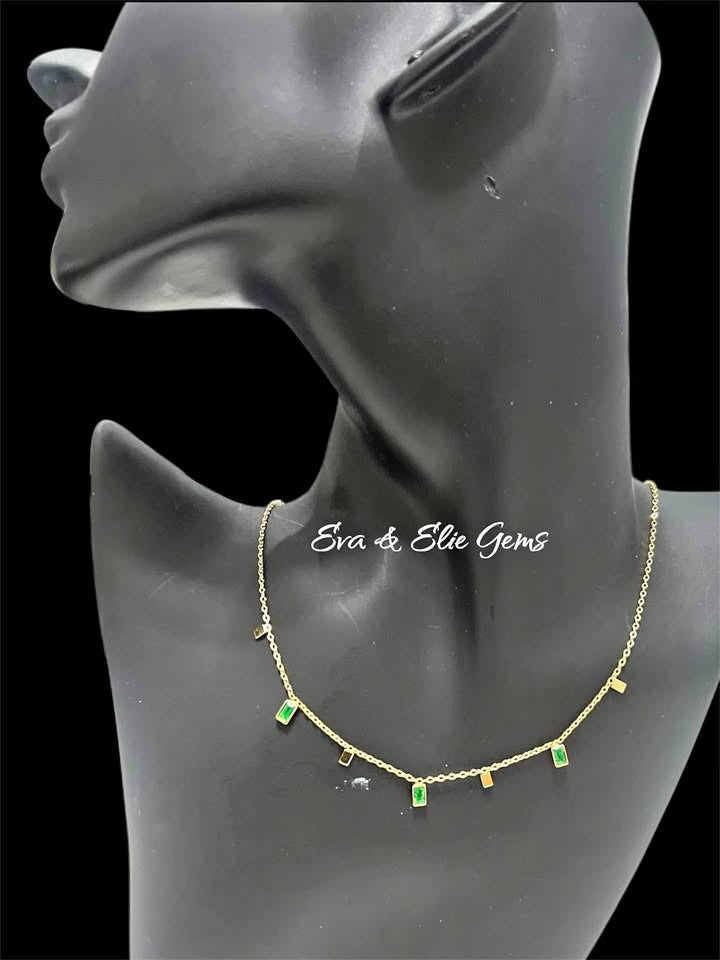 Elegant 18K gold vermeil necklace with rectangular emerald stones on a black mannequin, luxurious jewelry.