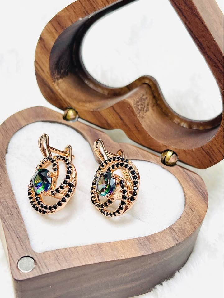 Angled view of 585RG rose gold earrings featuring striking mystic topaz gemstones and black pavé settings.