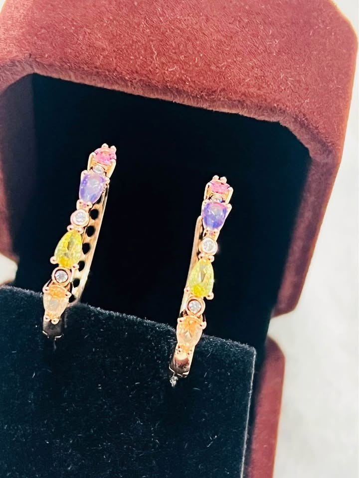  Angled view of 585RG rose gold stacked tourmaline hoop earrings showcasing the colorful gemstones.