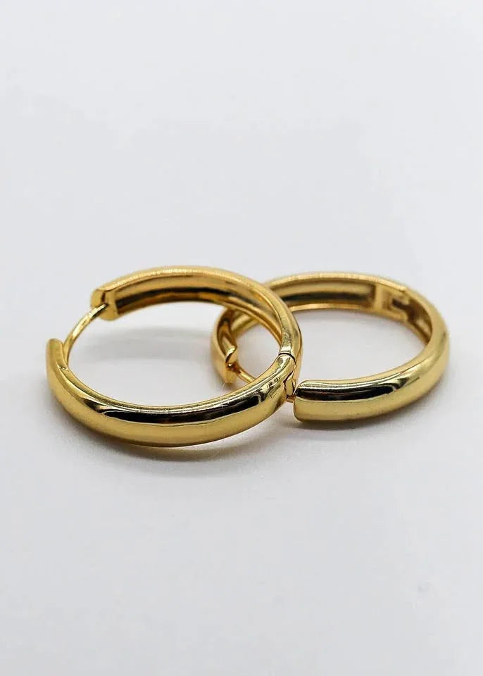 A pair of polished 18K gold vermeil thick hoop earrings, perfect for daily wear.
