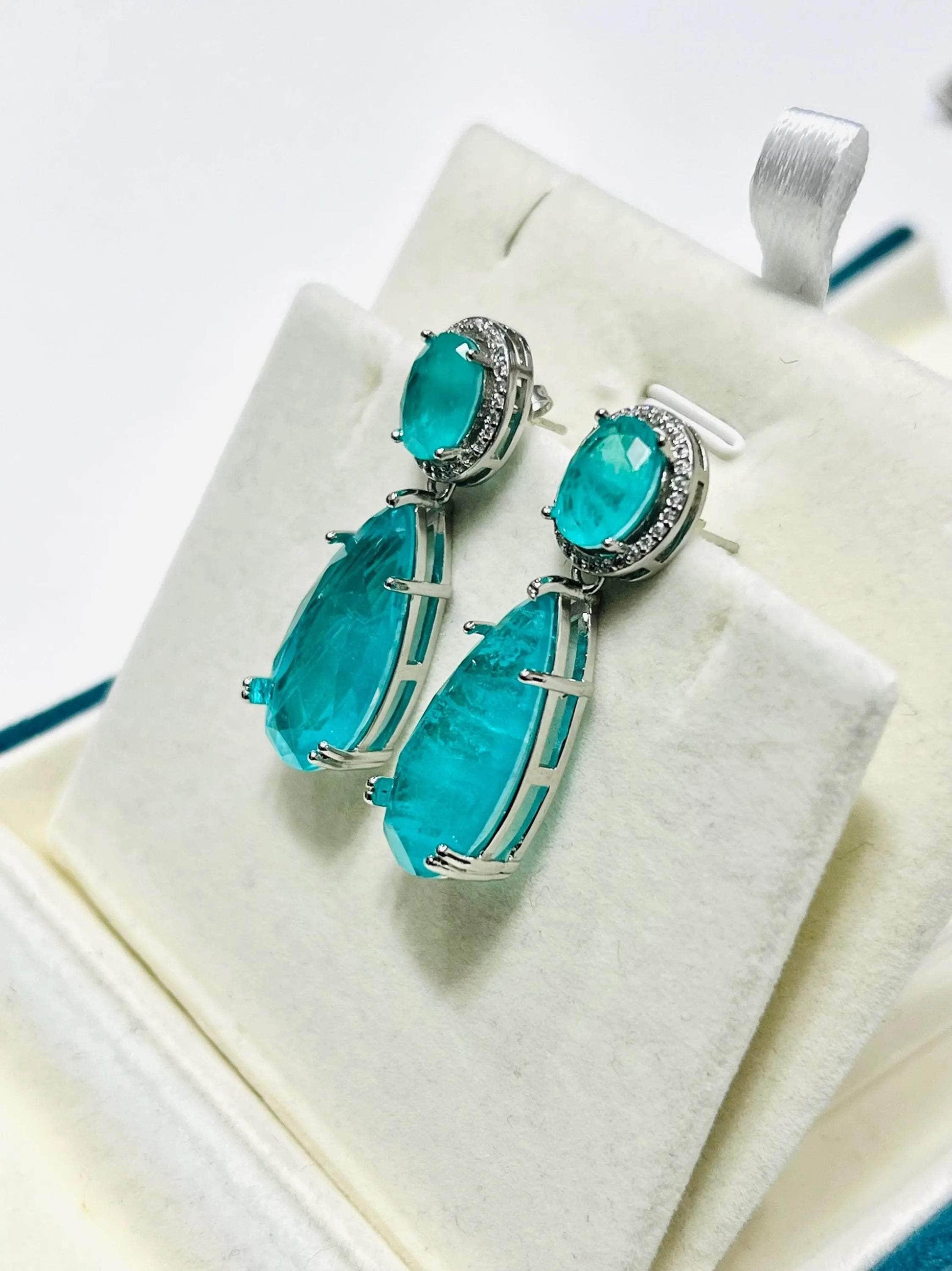  Beautiful aqua Paraiba tourmaline drop earrings with white gold settings and diamond accents.