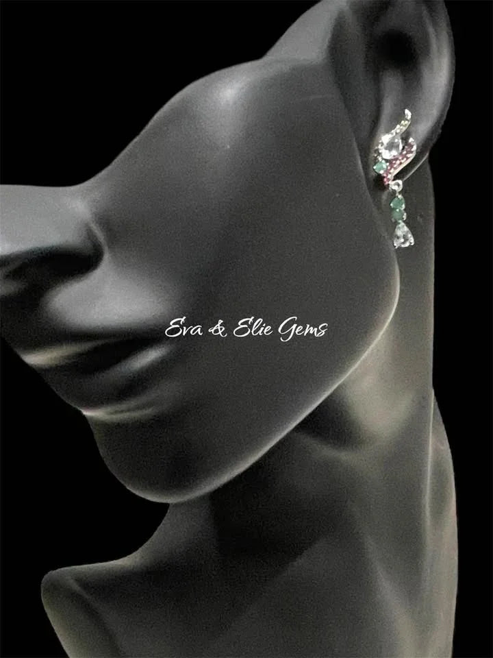 Sterling silver aquamarine, emerald, and garnet earring worn on a black mannequin, side view.