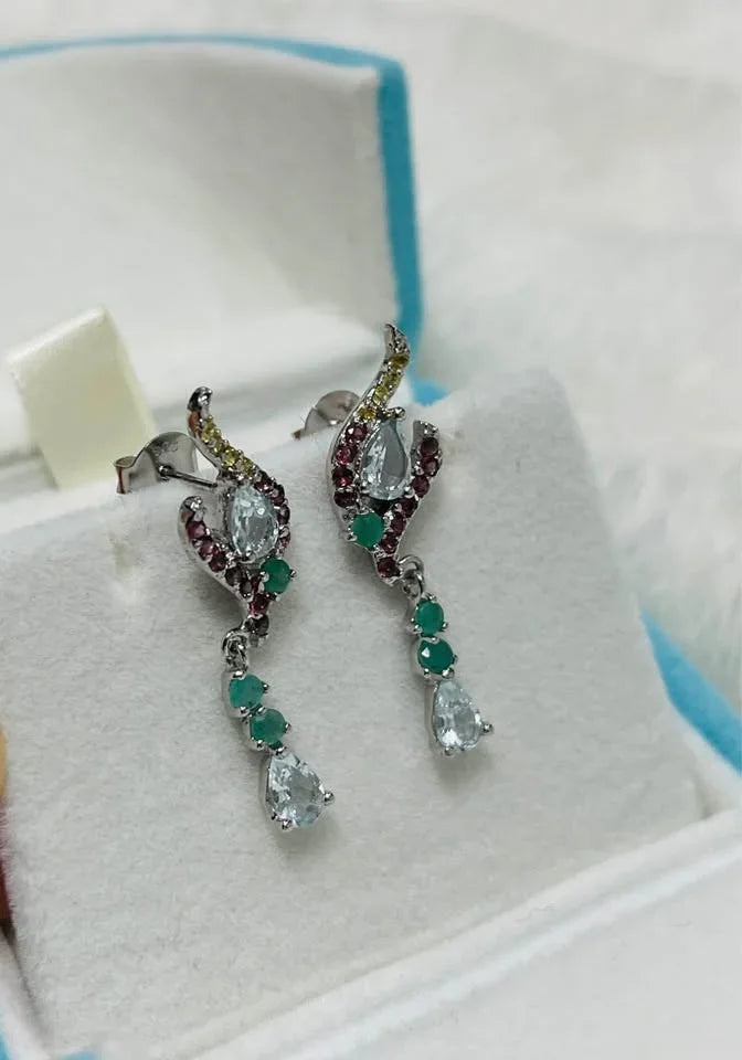 Natural aquamarine, emerald, and garnet sterling silver earrings presented in a light blue jewelry box.