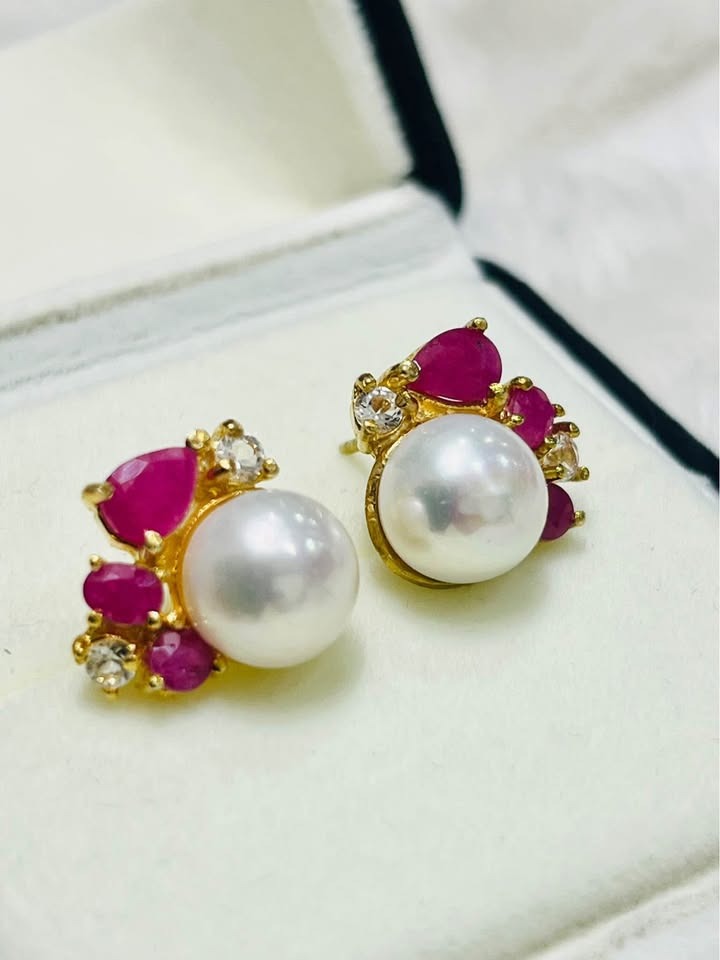  Artisan-crafted South Sea pearl earrings, featuring brilliant rubies and shimmering white topaz in a display box.