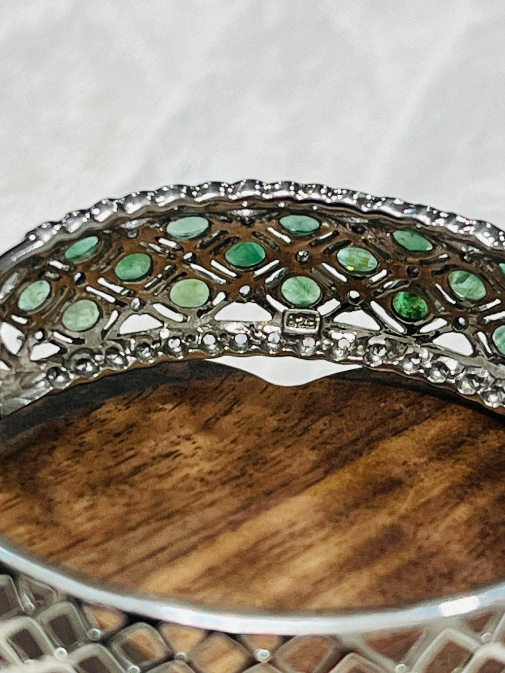 Close-up of the interior of an Aztec emerald and tanzanite bangle, revealing intricate silverwork.