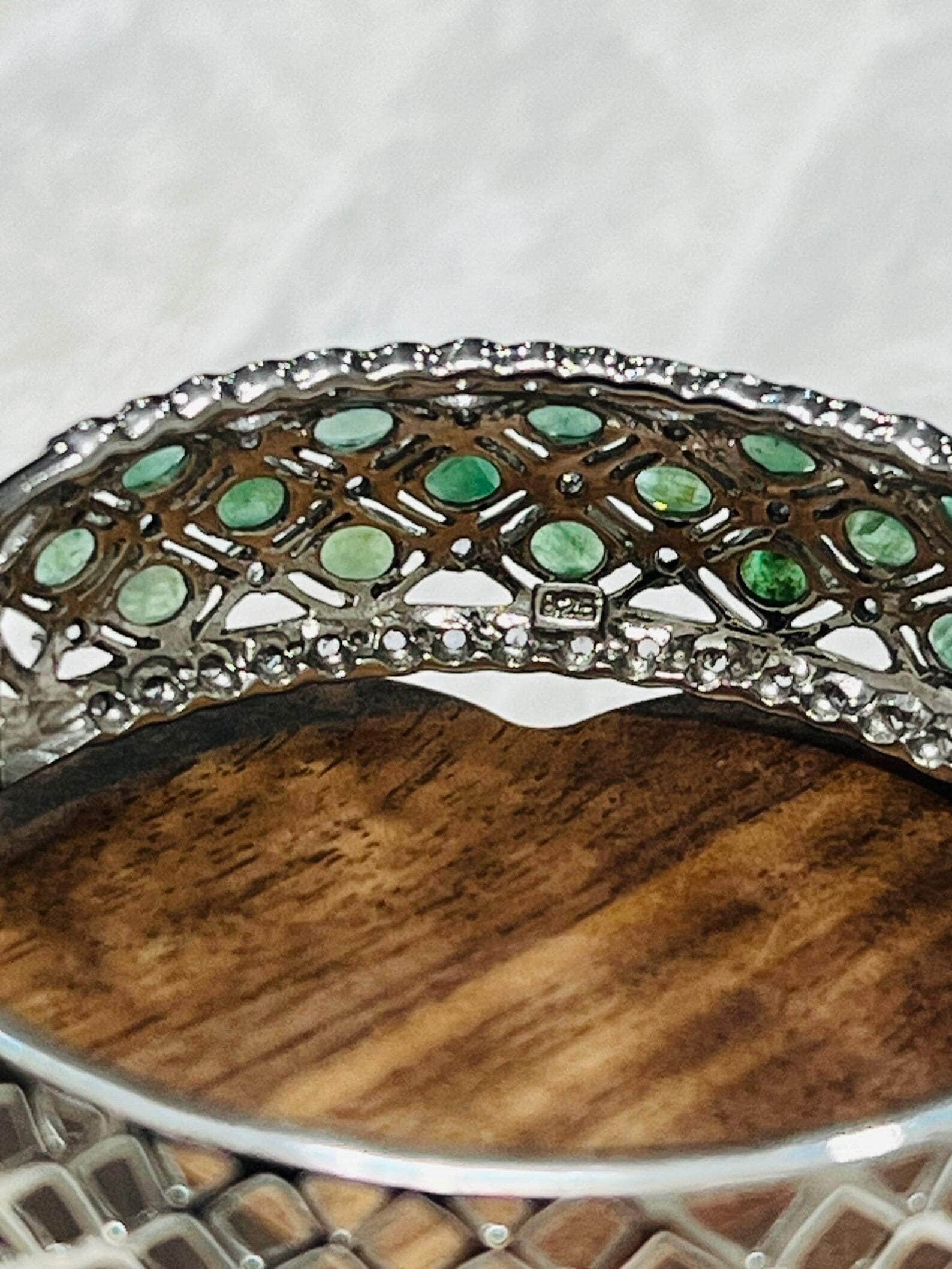 Close-up of the interior of an Aztec emerald and tanzanite bangle, revealing intricate silverwork.