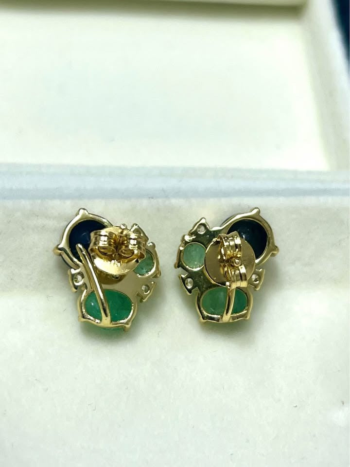 Back view of Colombian emerald and sapphire stud earrings showing gold posts and backings.