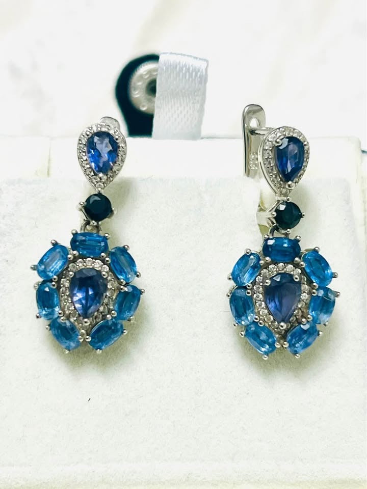  Front view of elegant handmade dangle earrings featuring blue sapphires and iolites, perfect for special occasions.

