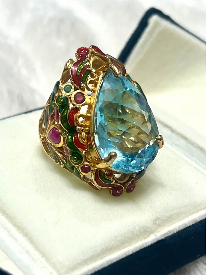 Angled view of a 22ct natural blue topaz antique royal handmade ring in a jewelry box.