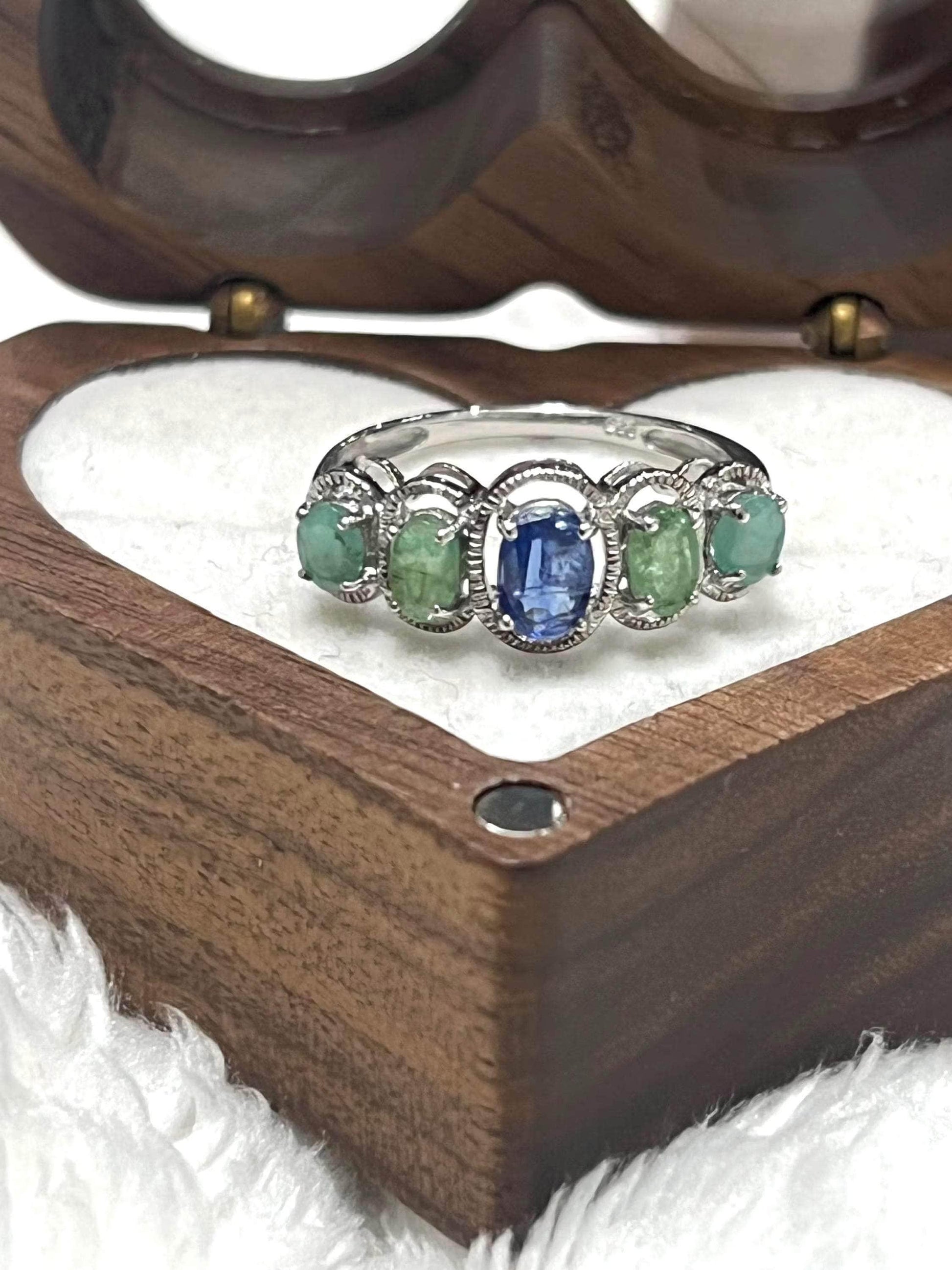 Bochic Kyanite and Colombian Emerald ring, a vibrant multi-gemstone design in a heart-shaped wooden box.

