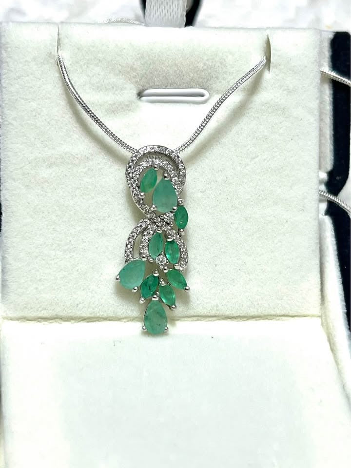 Exquisite natural Colombian emerald and diamond pendant necklace, featuring pear and round cut emeralds