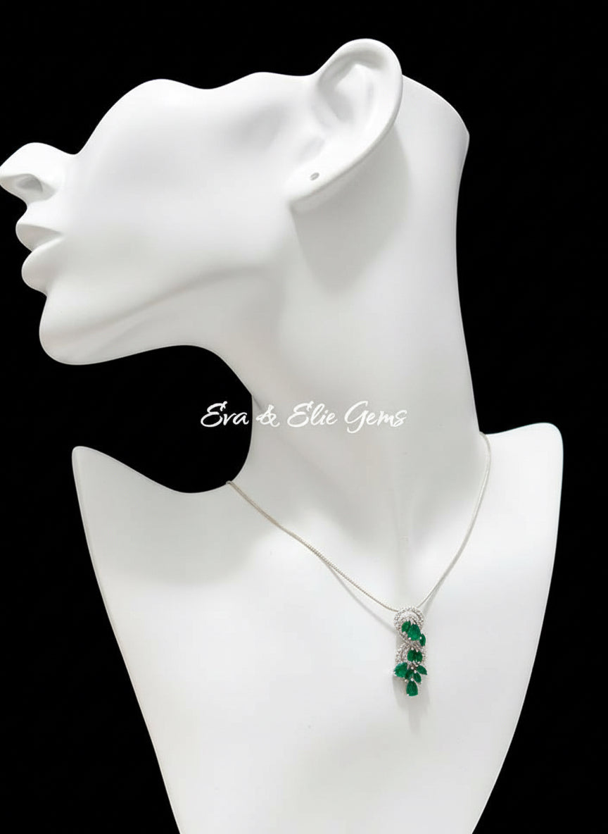 Elegant natural Colombian emerald pendant necklace with diamond accents, displayed on a black mannequin.