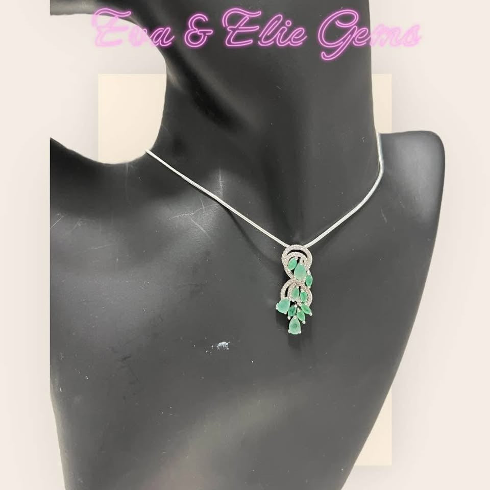 Beautiful natural Colombian emerald and diamond necklace on a mannequin, showcasing its graceful design.