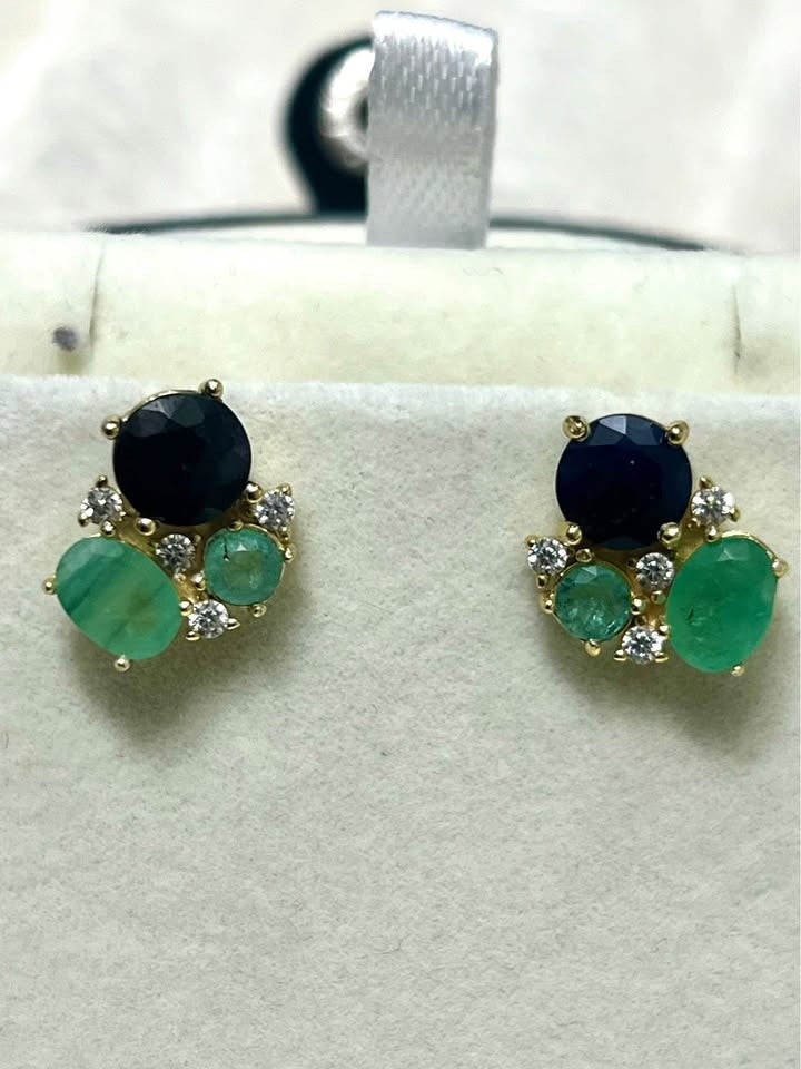 Exquisite Colombian emerald and sapphire stud earrings with accent diamonds in gold setting.
