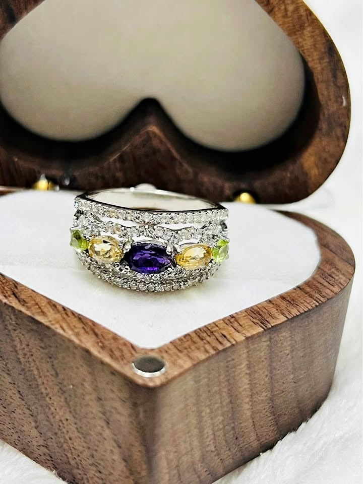 Stunning natural gemstone ring with vibrant amethyst, peridot, and citrine, set in a dazzling band.