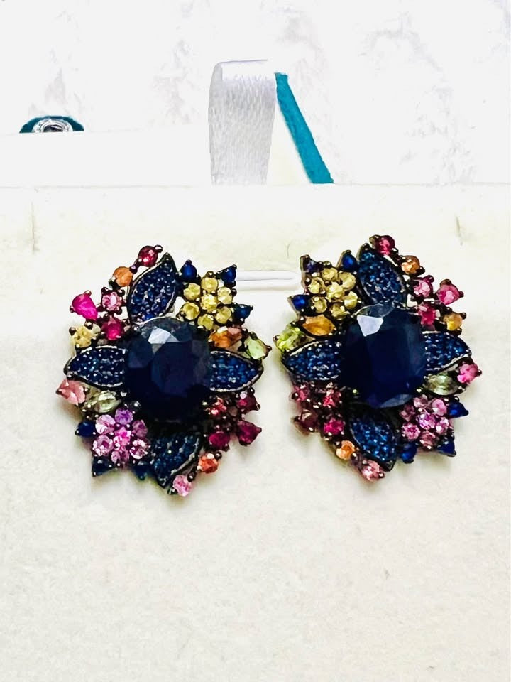 Pair of colorful natural sapphire flower stud earrings displayed beautifully in a jewelry box.