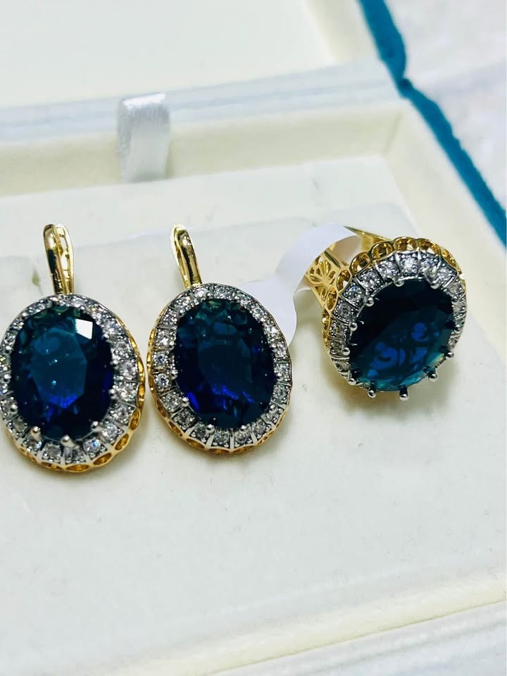 Full jewelry set featuring two stunning blue sapphire and diamond halo earrings and a matching ring.
