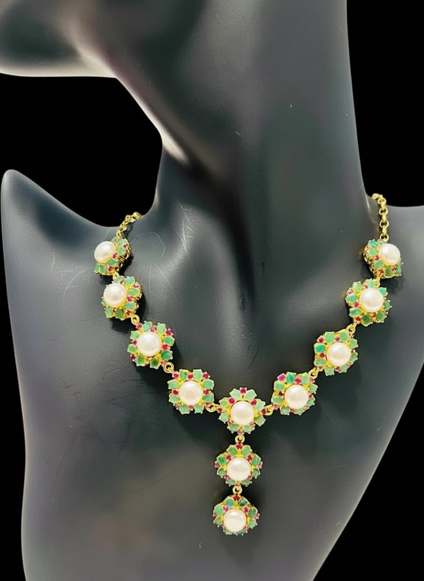 Designer South Sea pearl, Colombian emerald, and ruby choker necklace, a stunning statement piece.