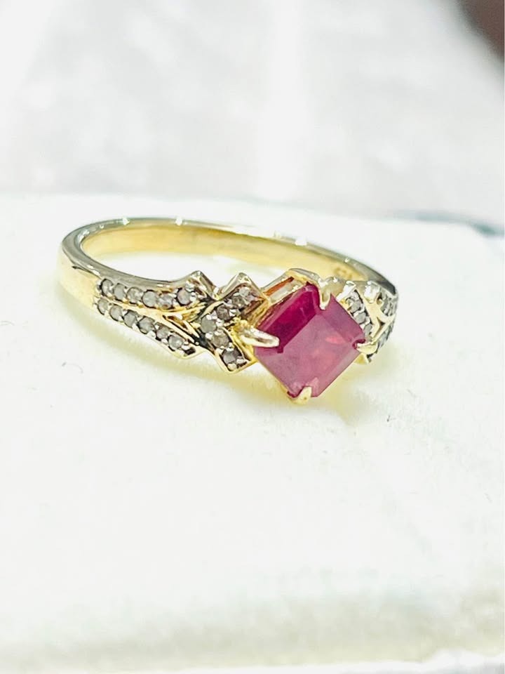 Detailed view of a natural square ruby ring with diamond accents.